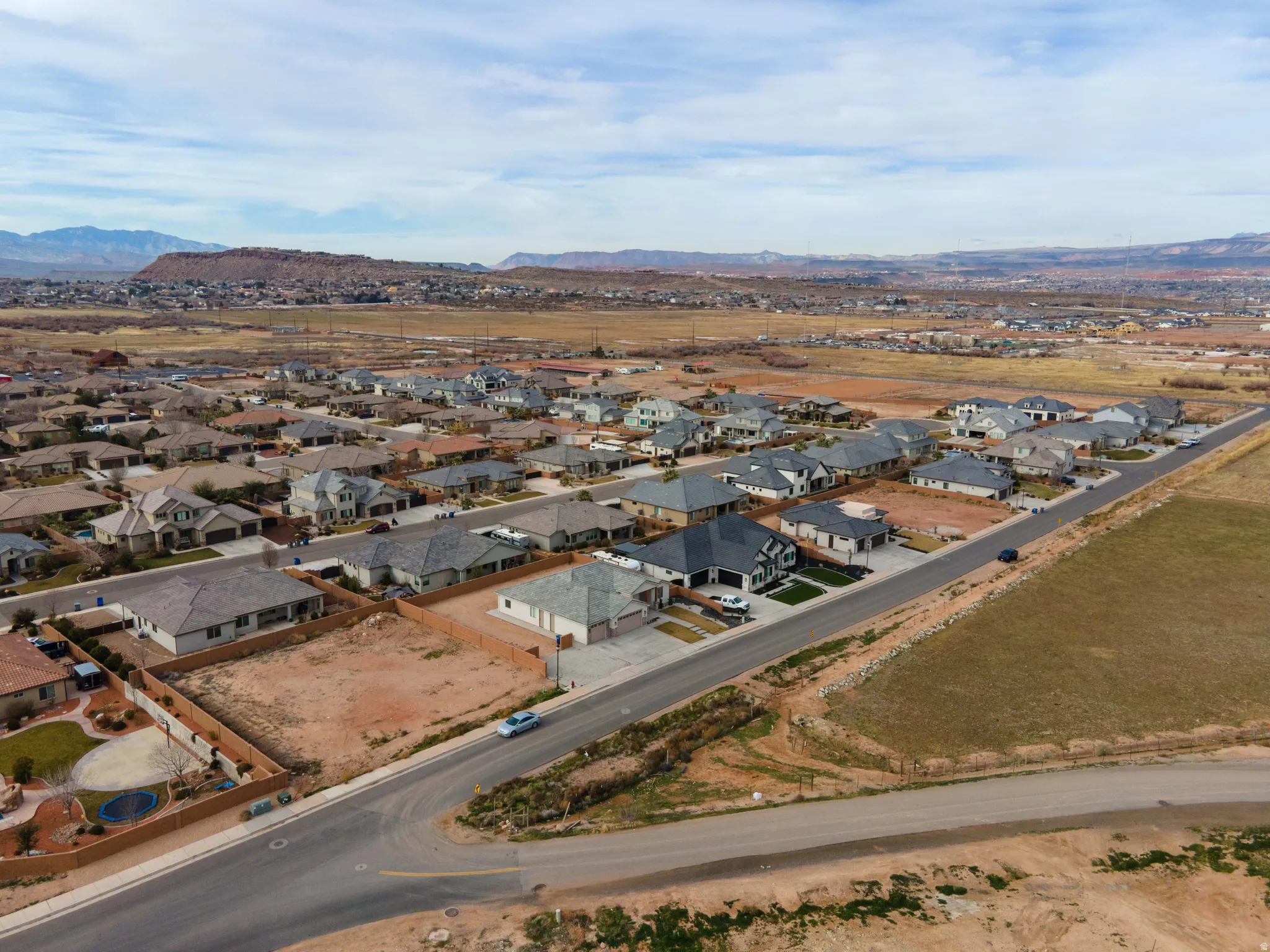 Aerial perspective of suburban area with a mountain backdrop