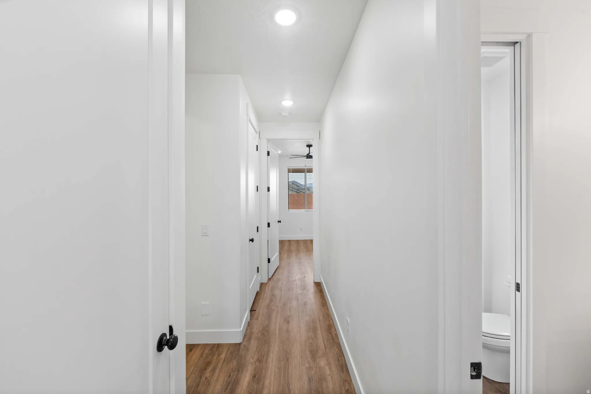 Hallway featuring recessed lighting and light wood-style floors