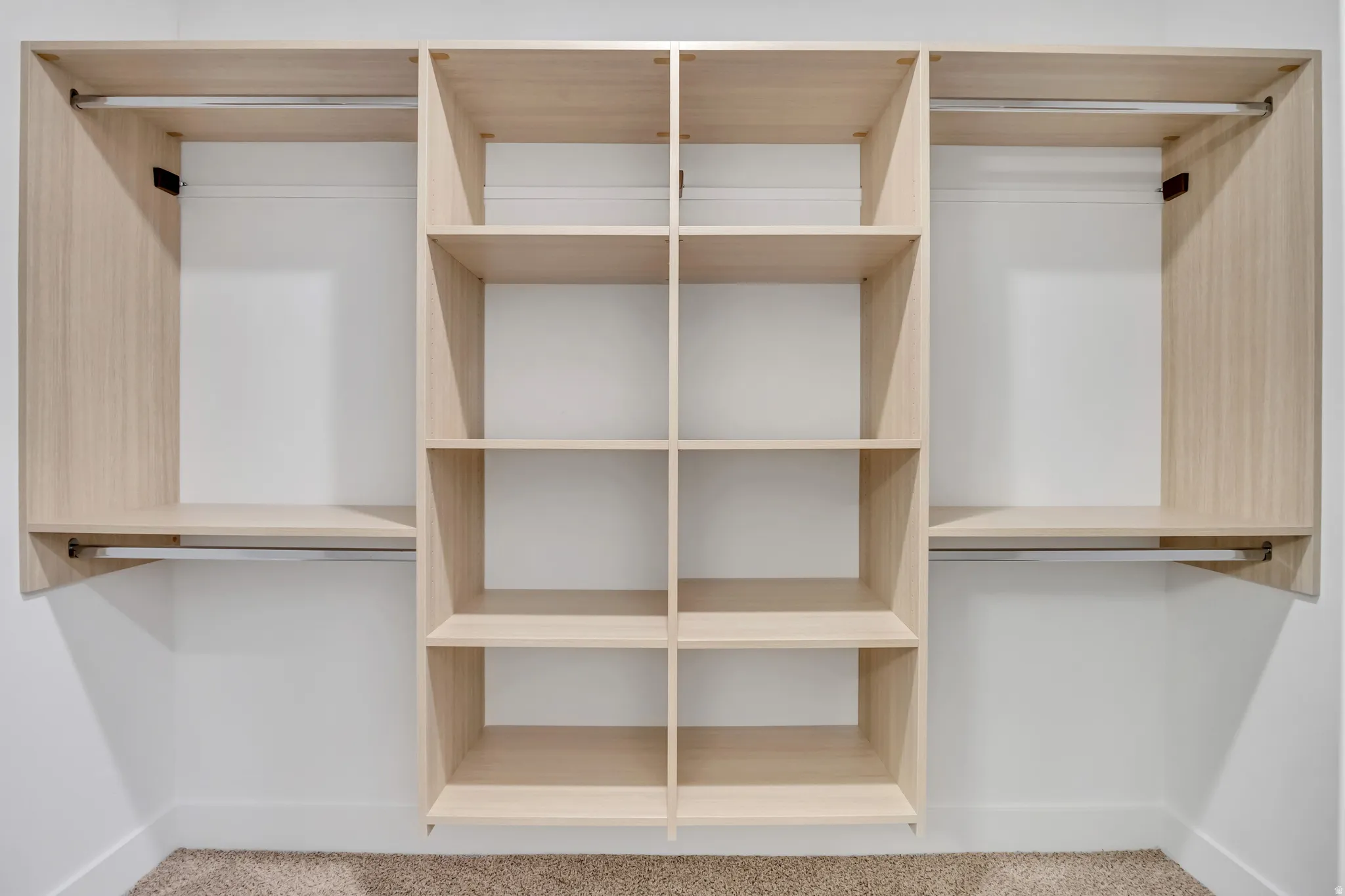 Built-in closet system featuring wood-finish shelving and hanging rods