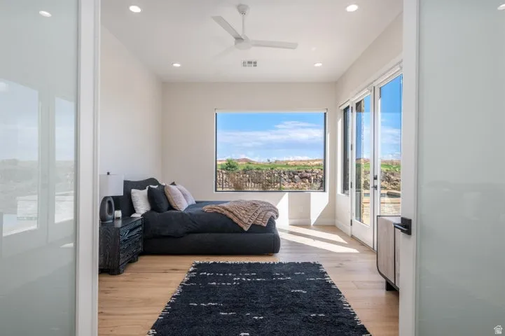 Living area with ceiling fan, light wood-style floors, and recessed lighting