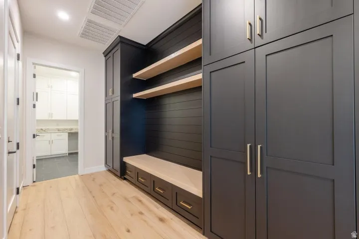 Mudroom featuring light wood-type flooring and baseboards