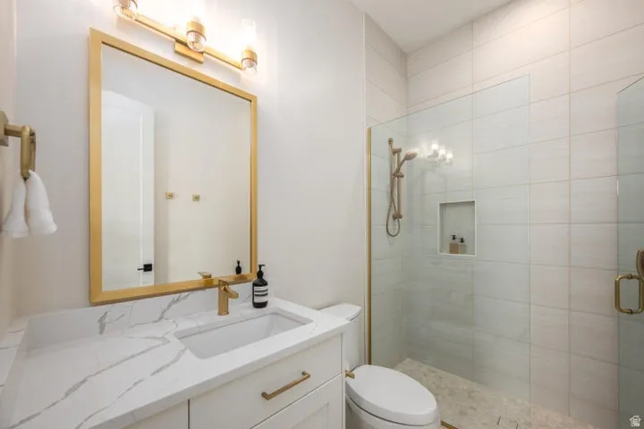 Full bathroom with vanity and a stall shower