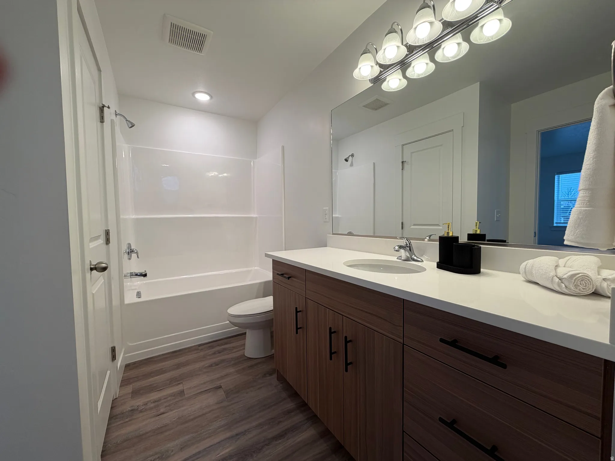 Premier bedrooms full bath featuring vanity, personal linen closet, and bathtub / shower combination