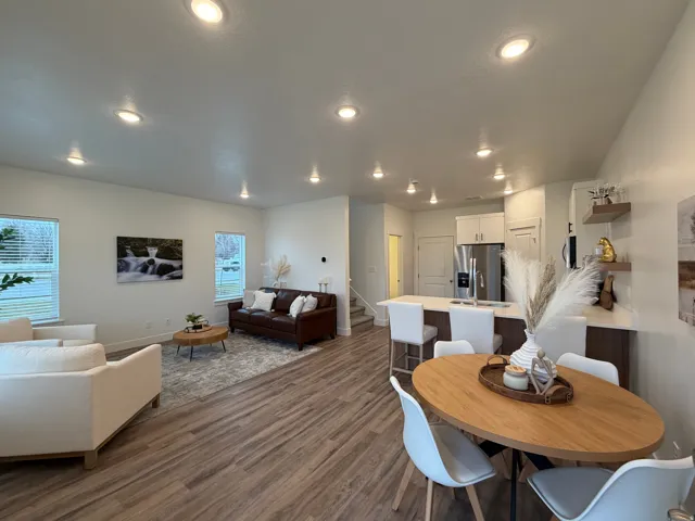 Dining area with dark wood-type flooring and recessed lighting