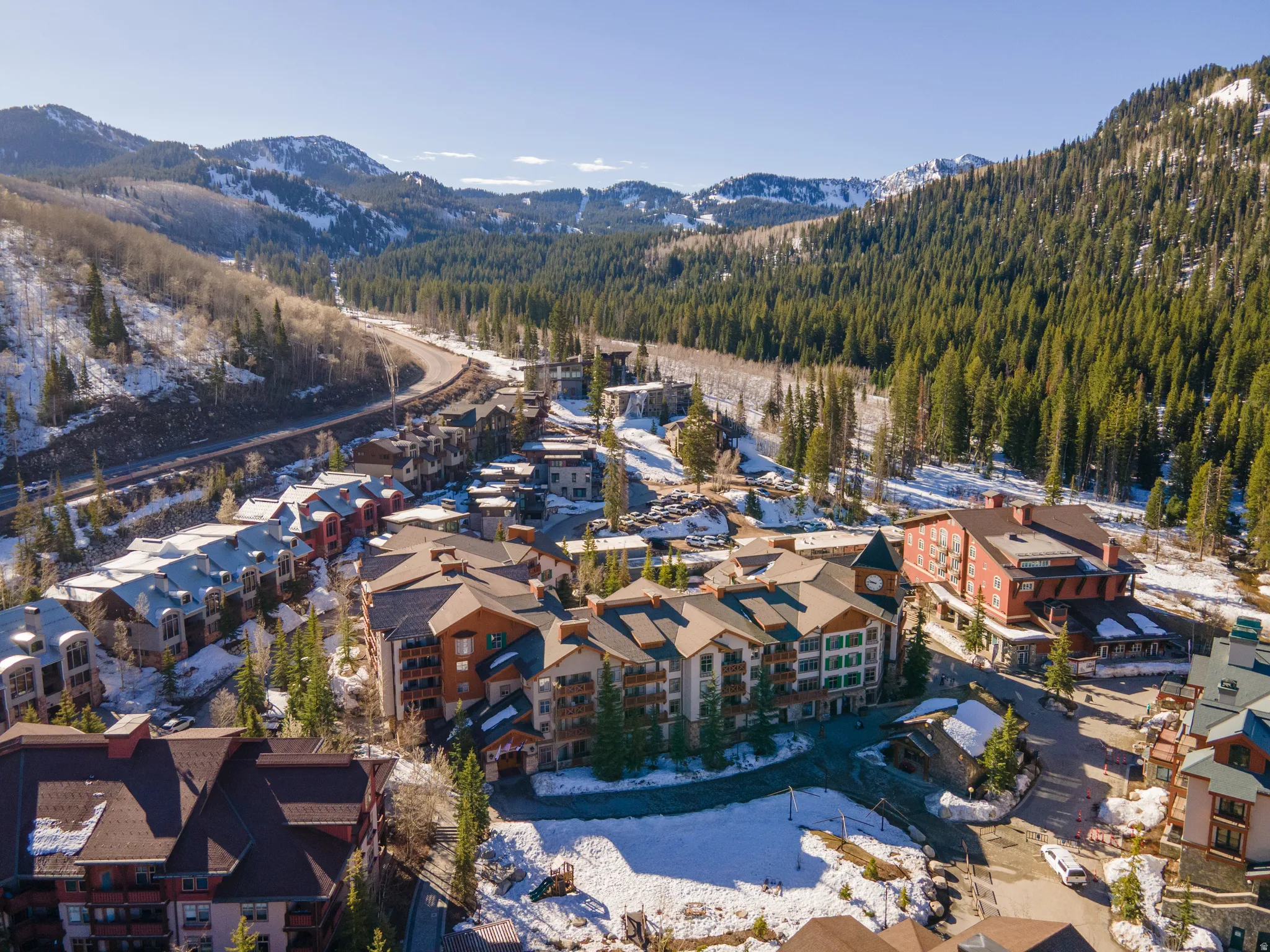 Aerial view of property and surrounding area with a mountain backdrop