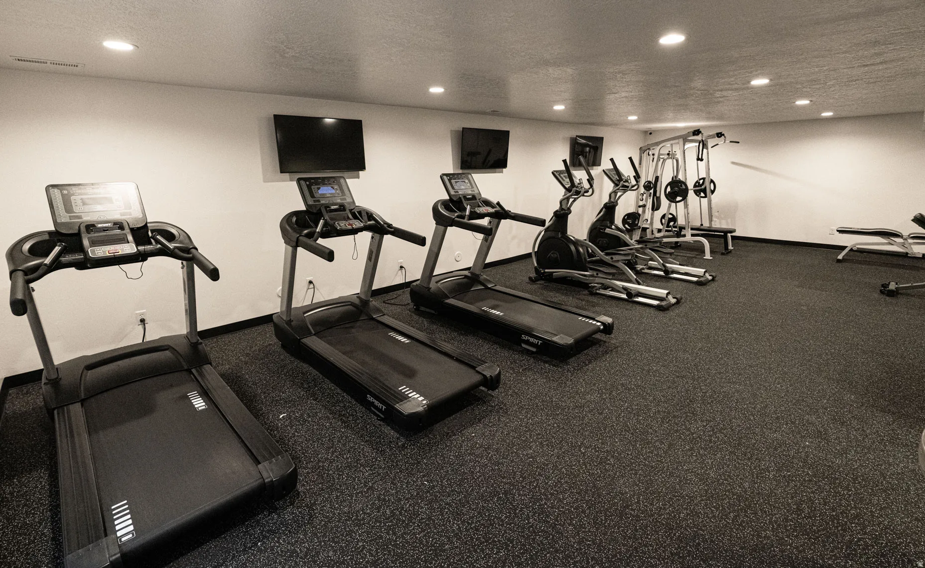 Gym with recessed lighting and a textured ceiling