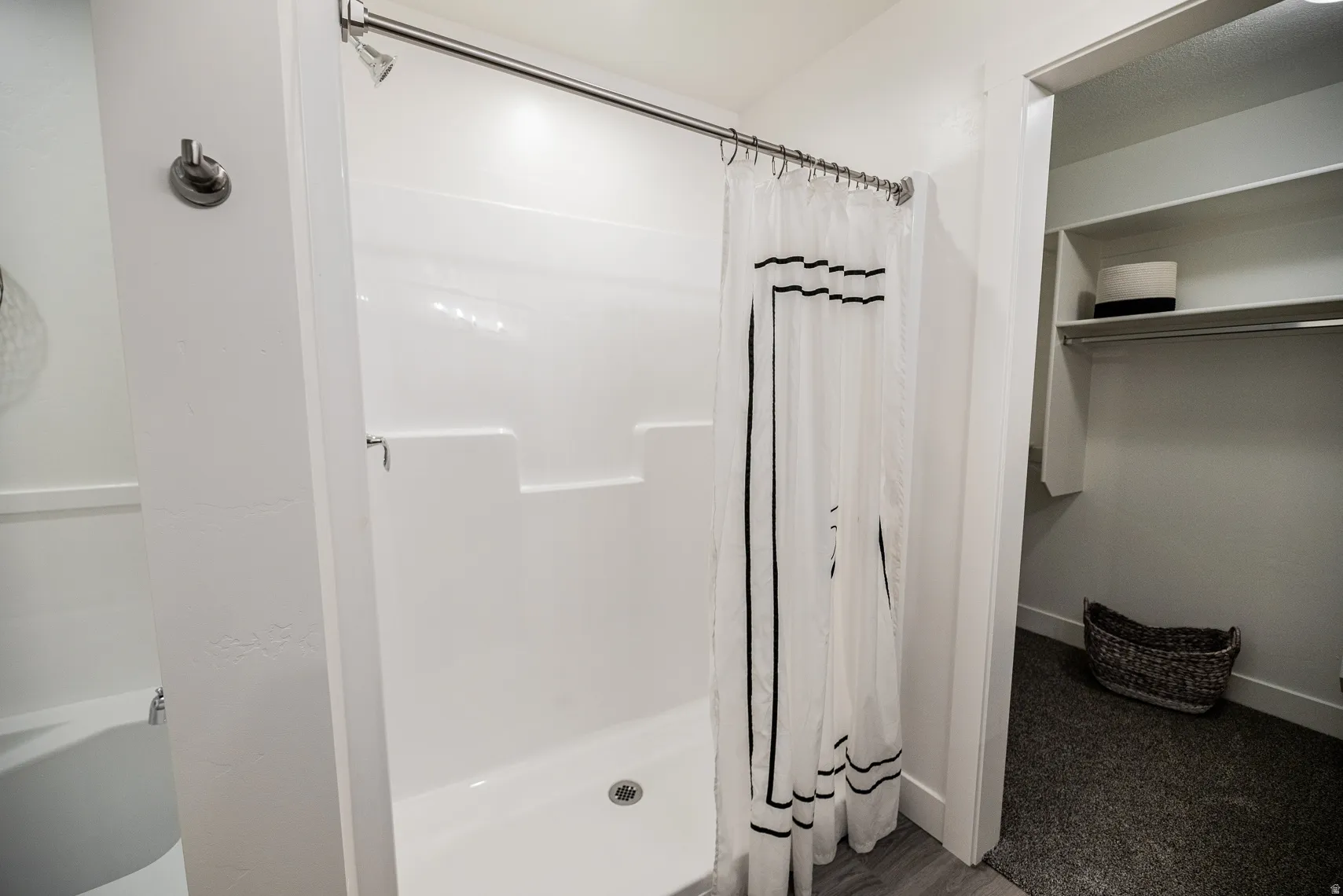 Bathroom with a stall shower and baseboards