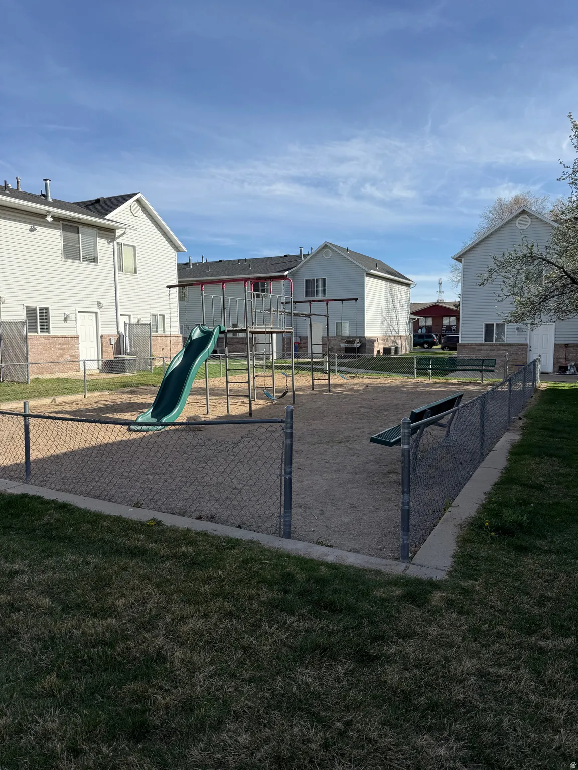 Community jungle gym featuring a gate and a residential view