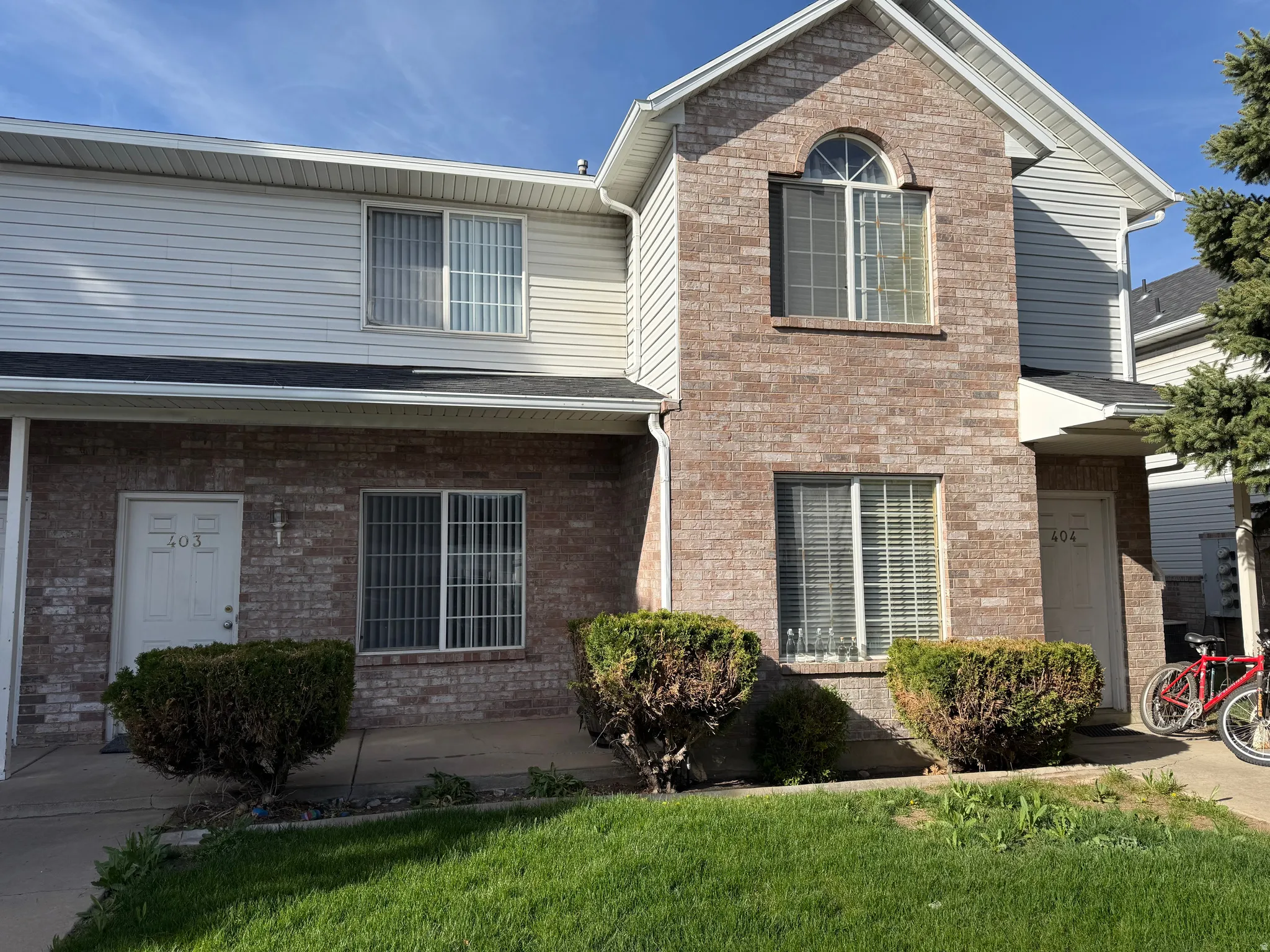 Traditional home with brick siding and a front yard