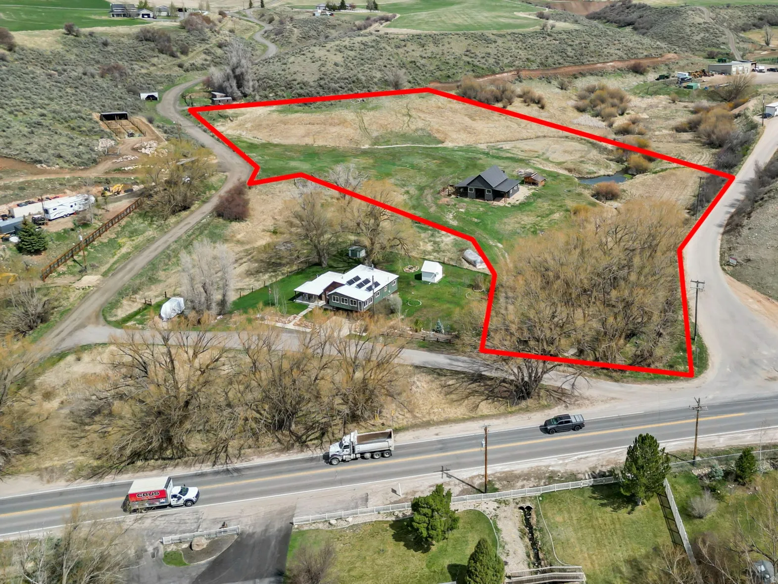 Overview of rural landscape featuring property boundaries highlighted and a mountainous background