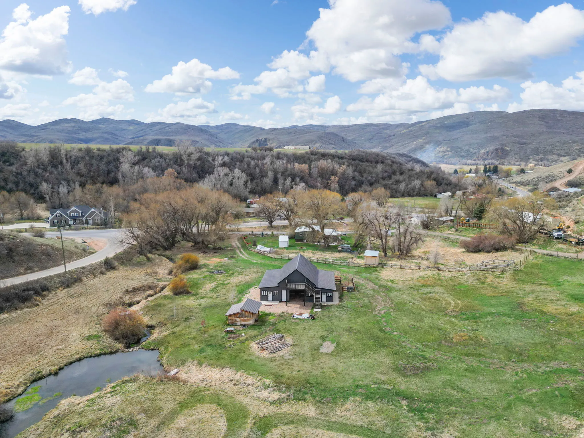 Aerial view of property and surrounding area featuring a mountainous background