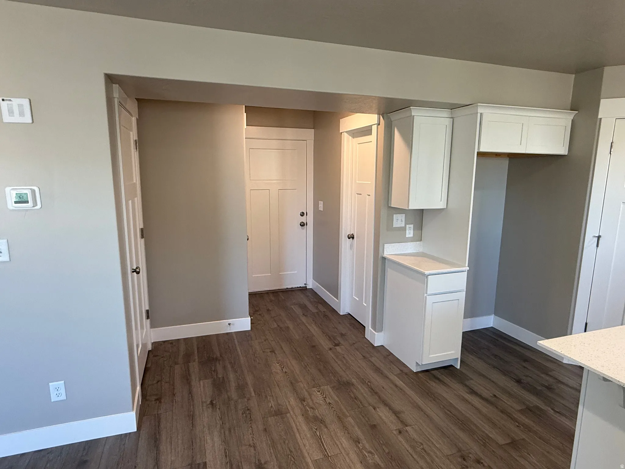Kitchen featuring white cabinets and dark wood finished floors