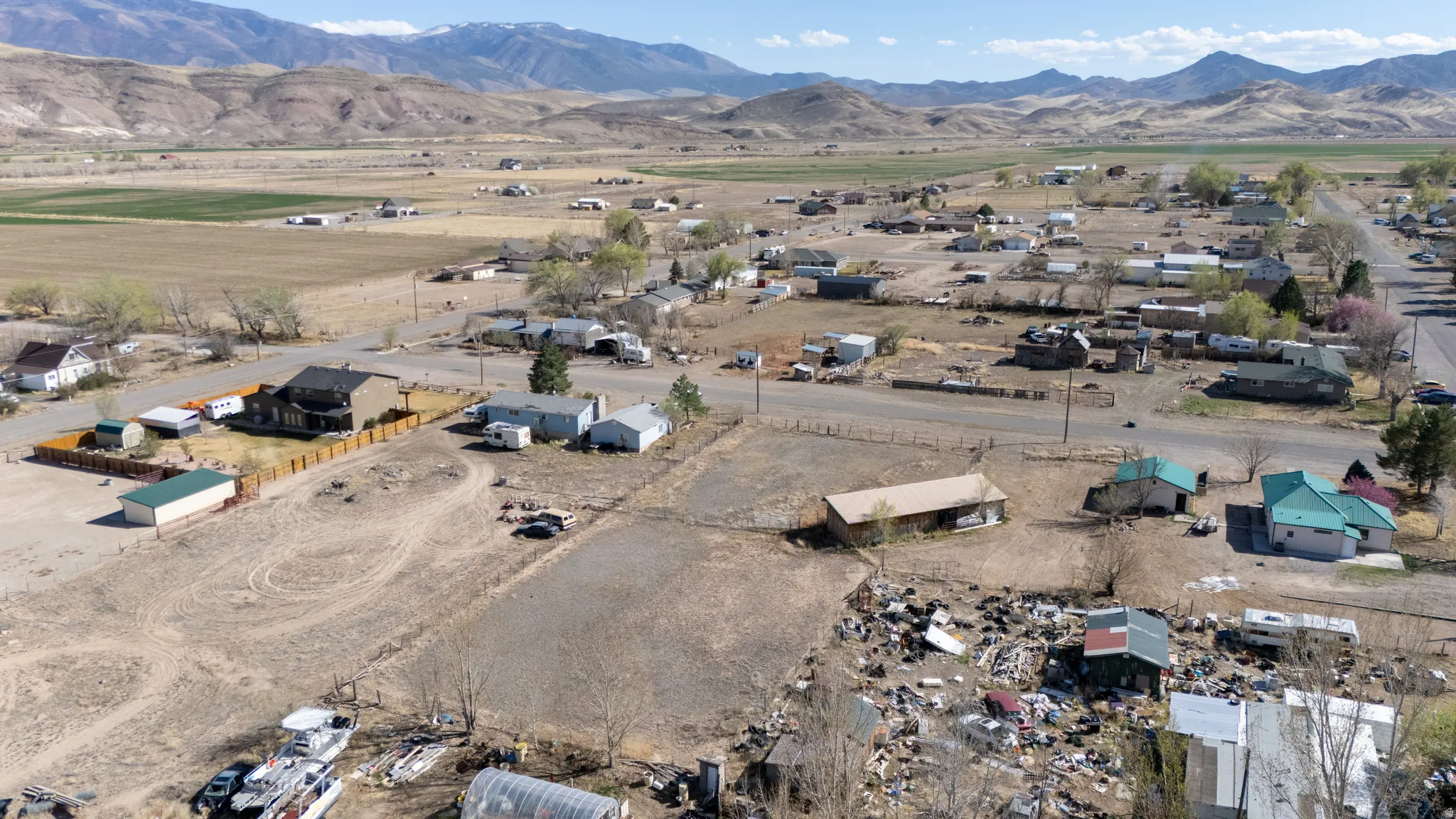 Aerial view of property and surrounding area with mountains and nearby suburban area