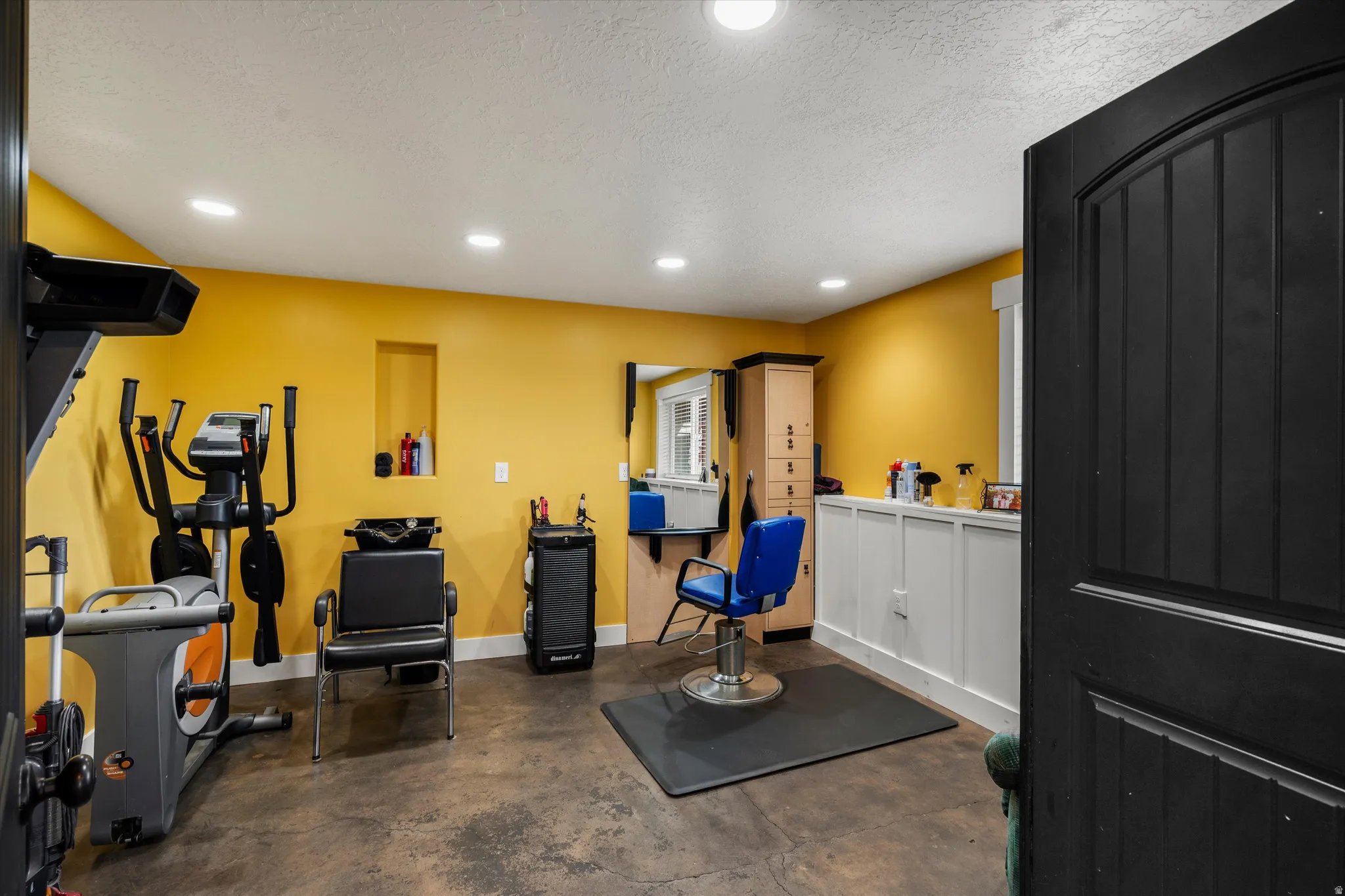 Workout room with recessed lighting and a textured ceiling