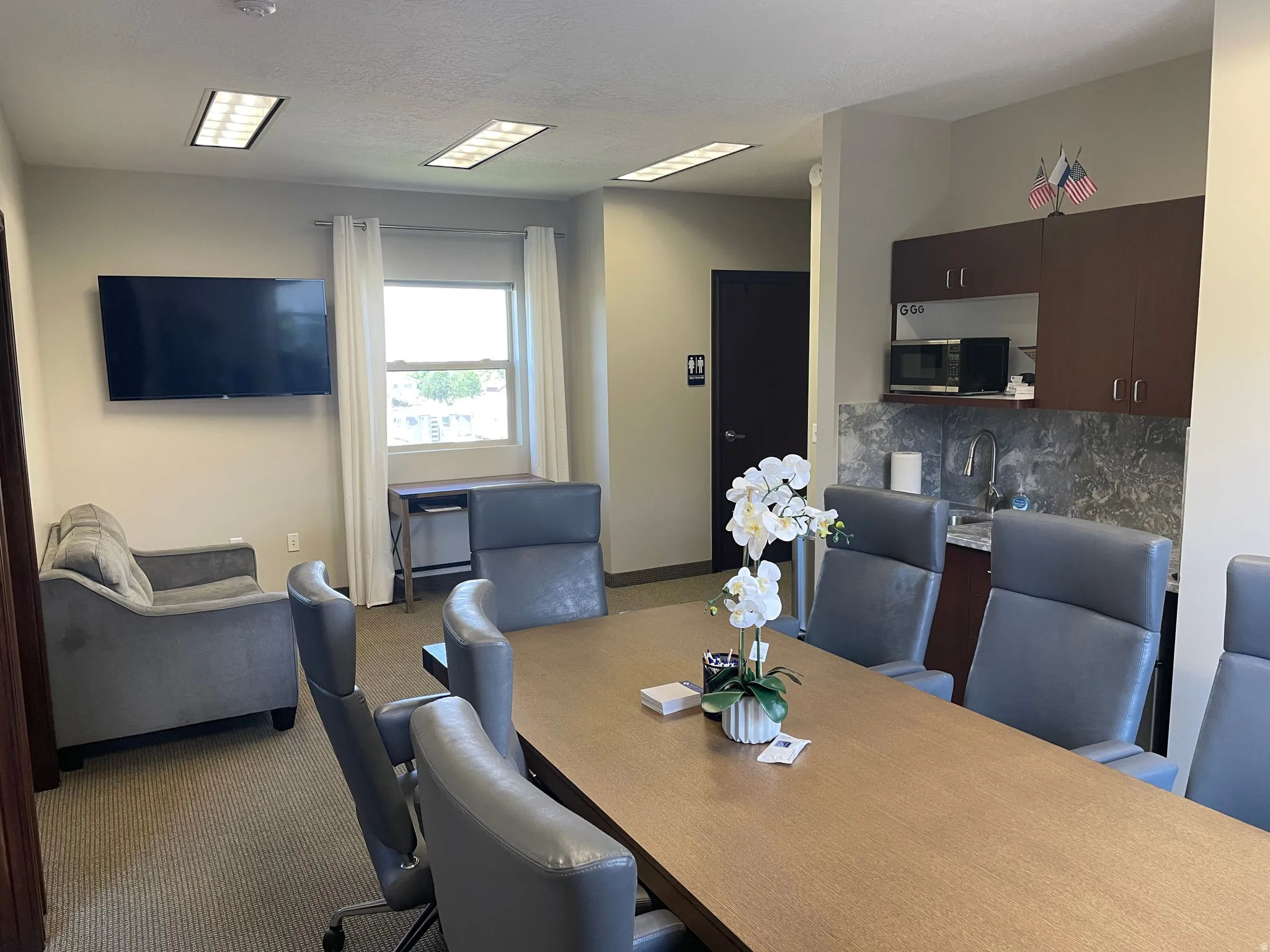 Dining area with dark carpet and baseboards