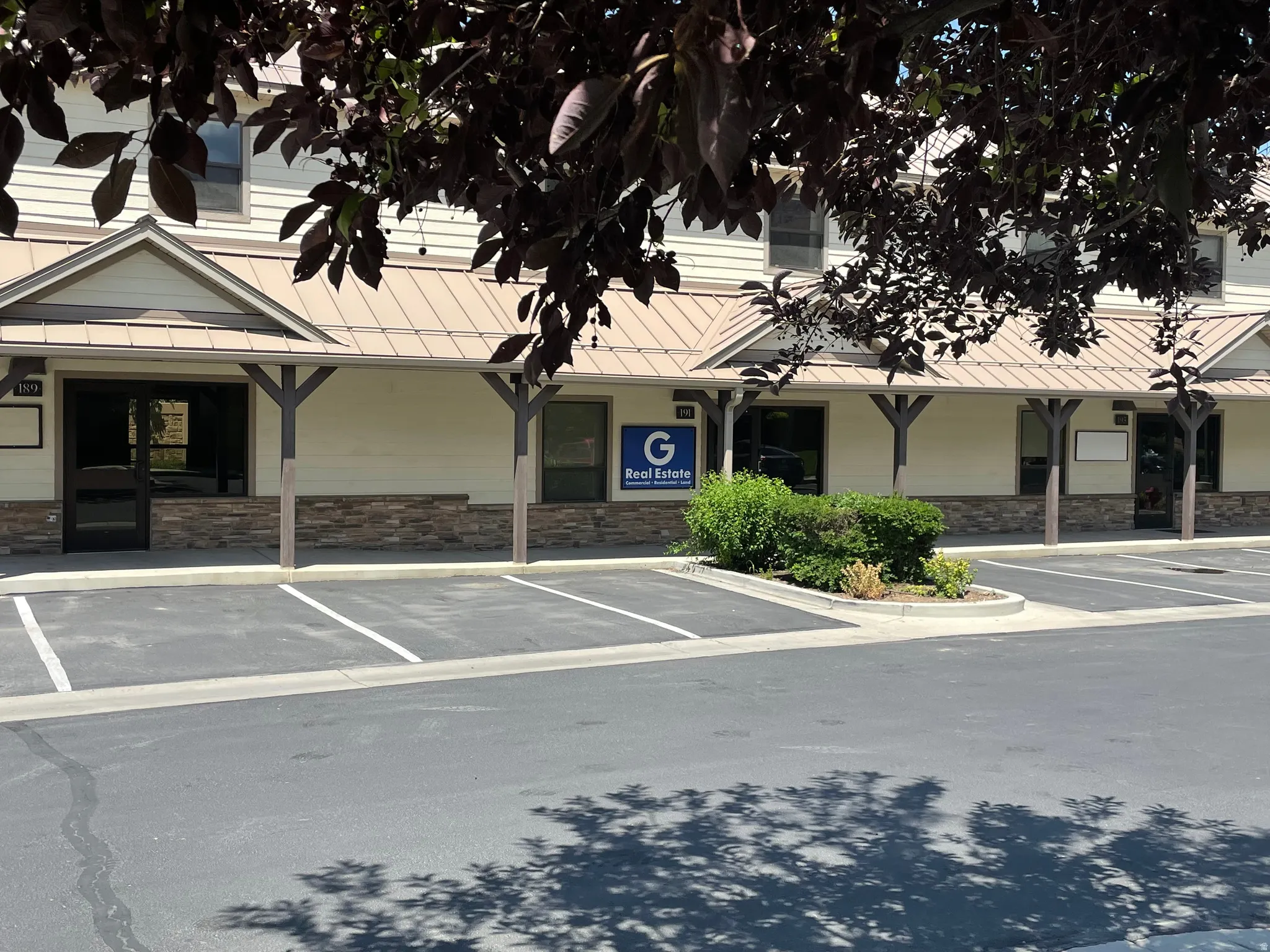 View of commercial property featuring uncovered parking