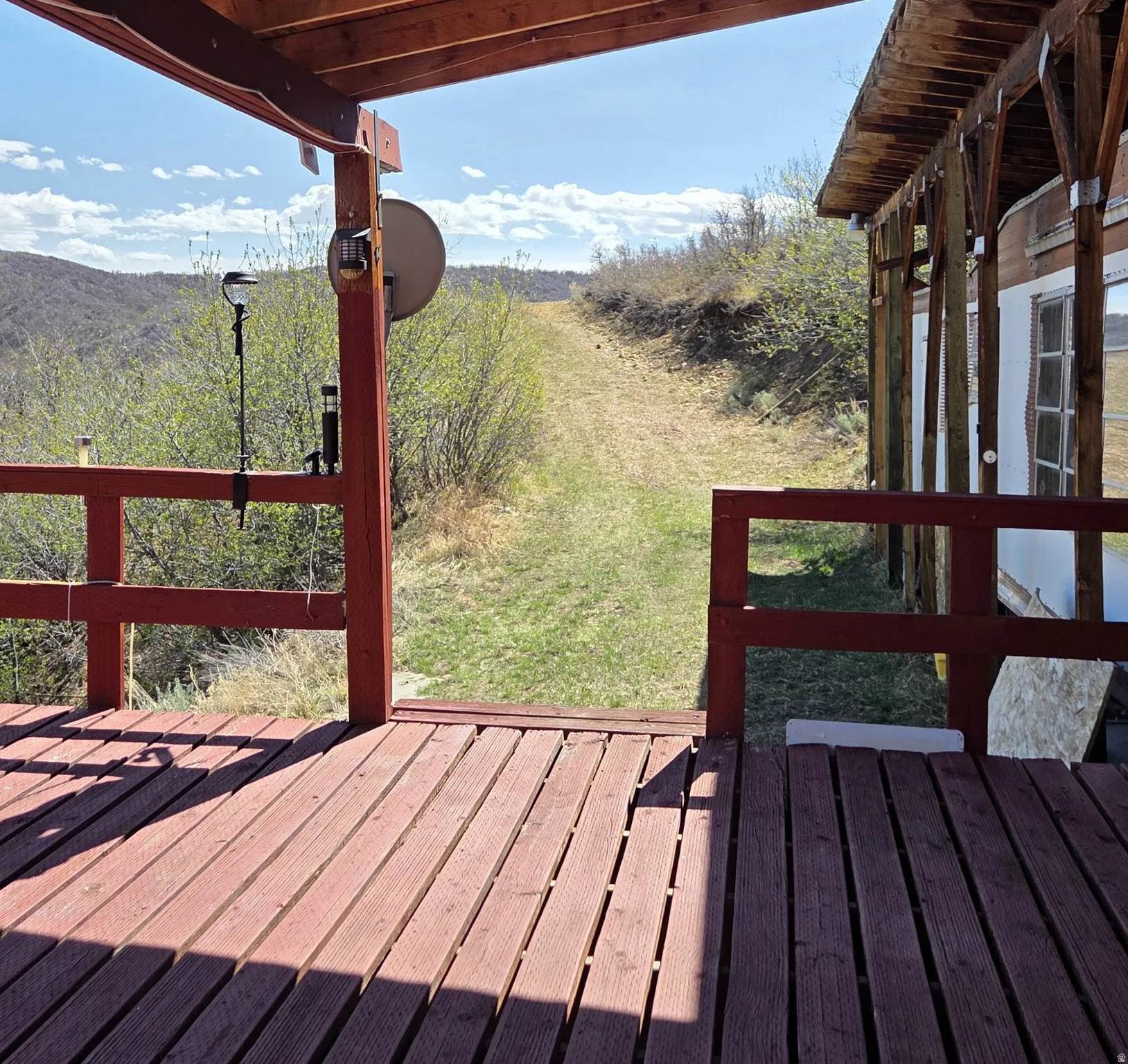 Wooden deck featuring a lawn