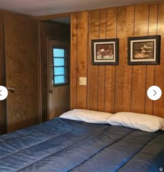 Bedroom with wood walls