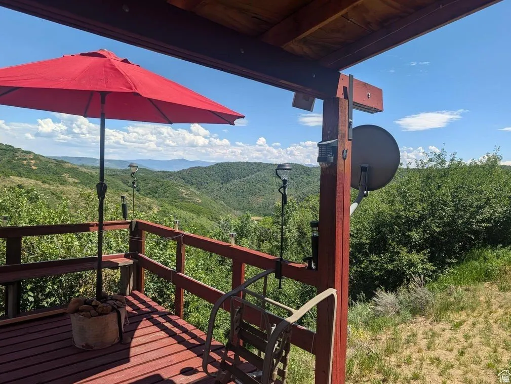 Wooden terrace featuring a mountain view