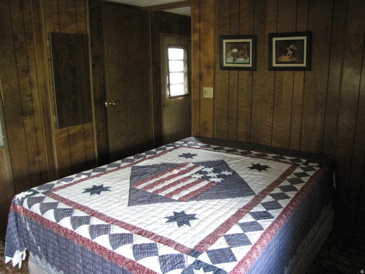 Bedroom with wood walls