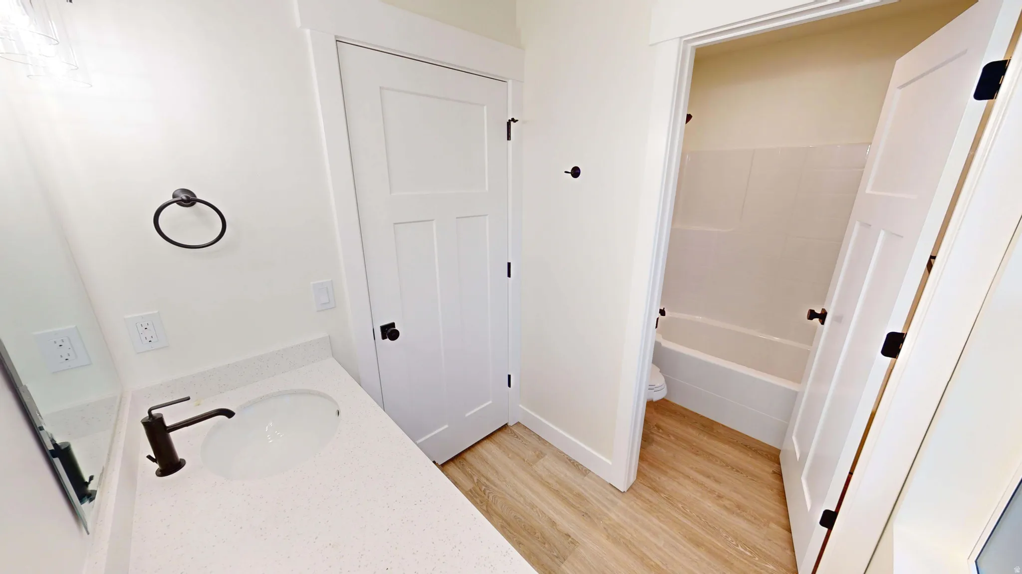 Full bathroom with vanity, light wood-style flooring, and bathing tub / shower combination