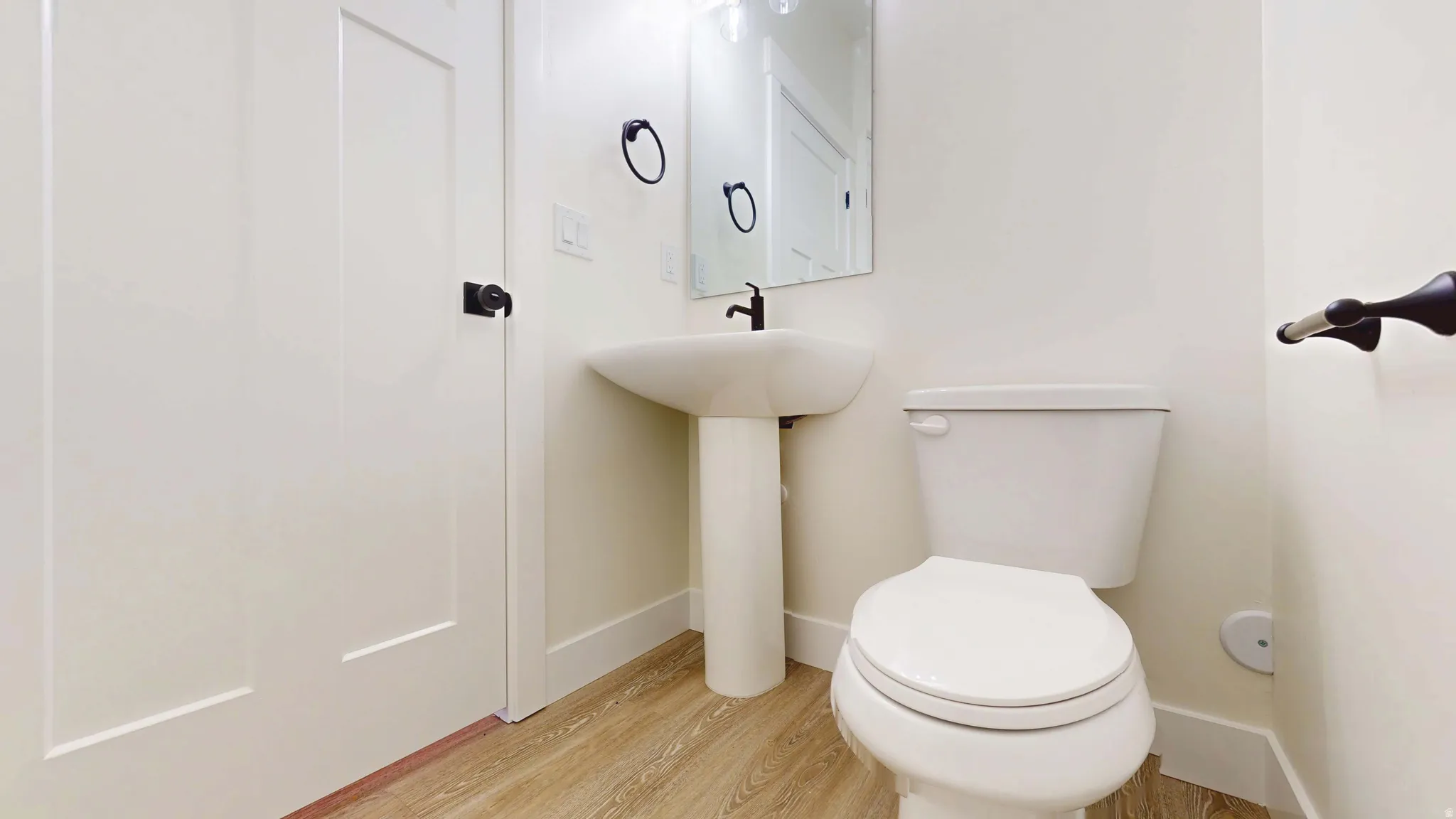 Bathroom featuring light wood finished floors and toilet