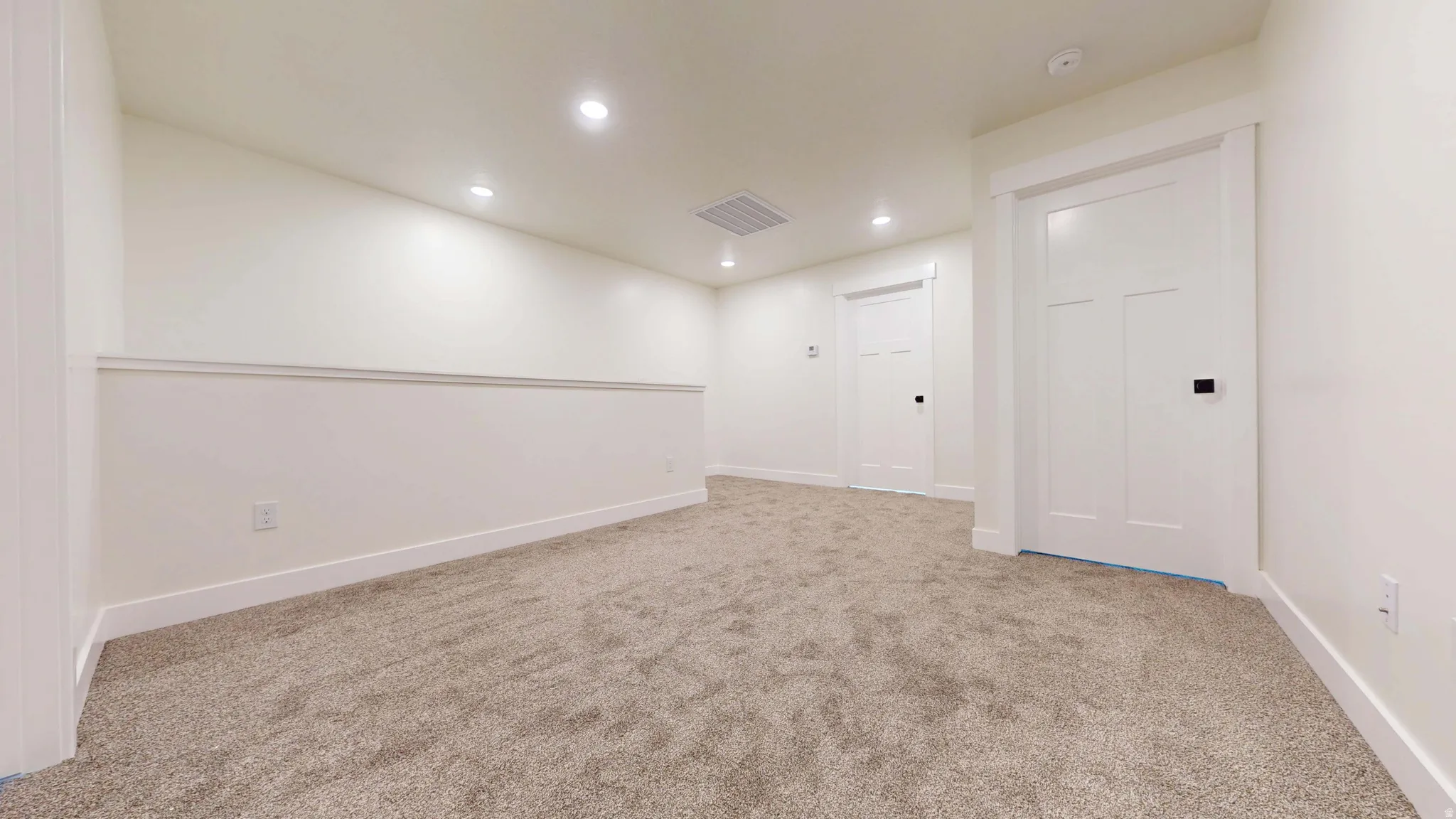 Spare room featuring recessed lighting and light carpet