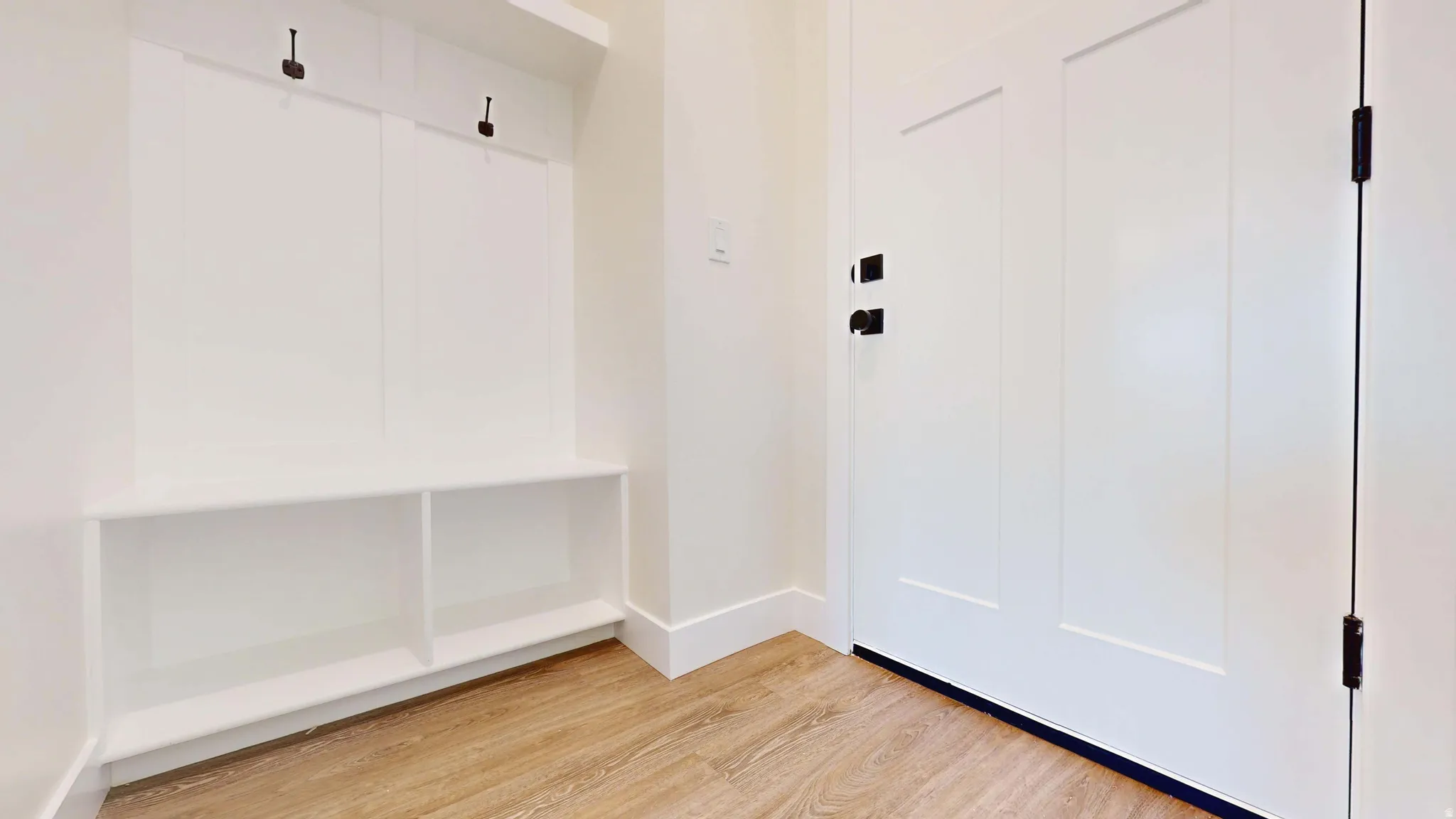 Mudroom featuring light wood finished floors