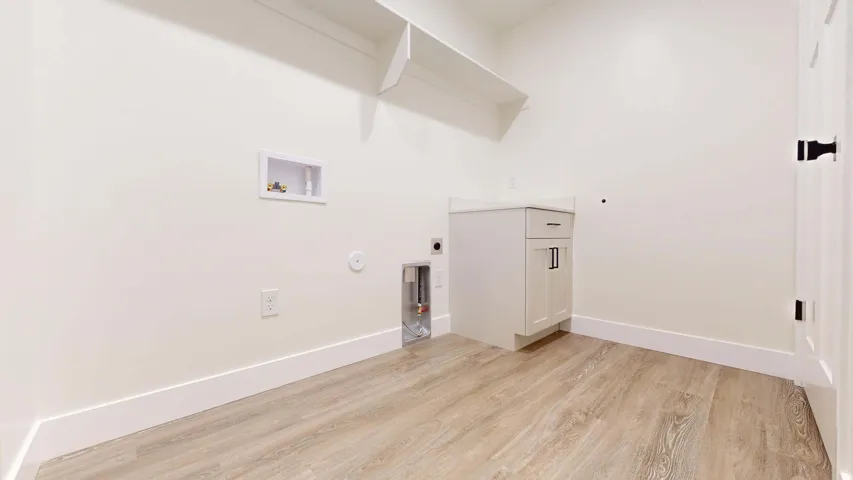 Laundry area featuring hookup for a gas dryer, light wood finished floors, washer hookup, and hookup for an electric dryer