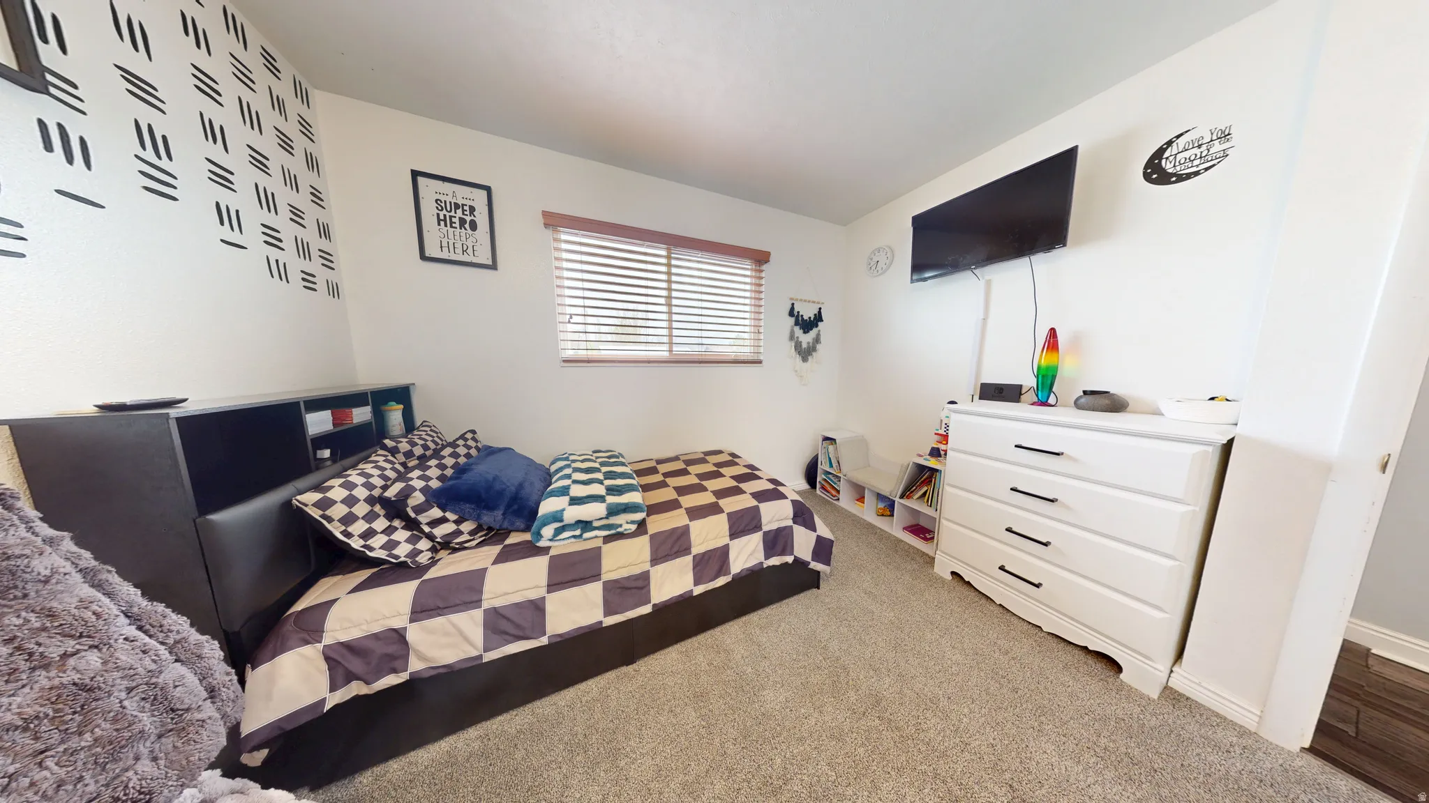 Bedroom with light colored carpet and baseboards