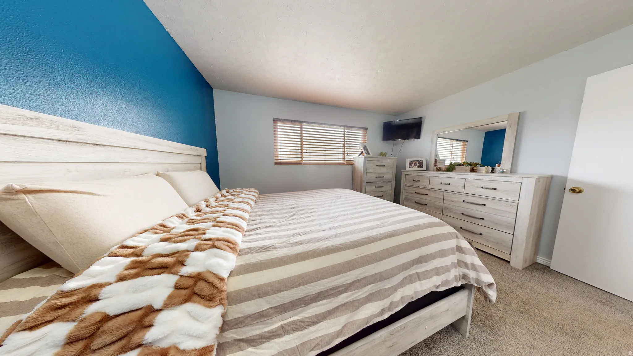 Bedroom featuring light colored carpet