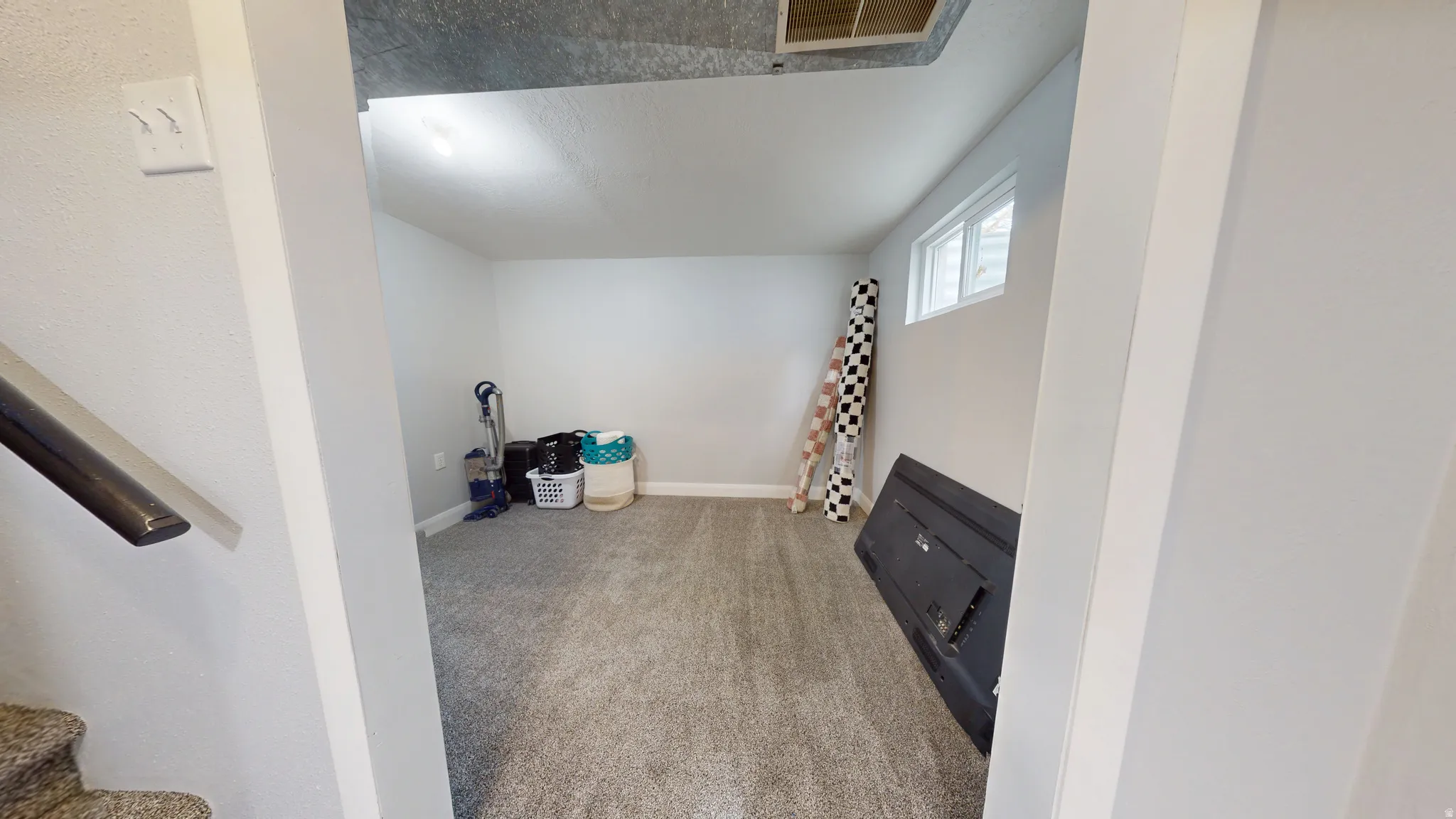 Below grade area with light carpet and baseboards