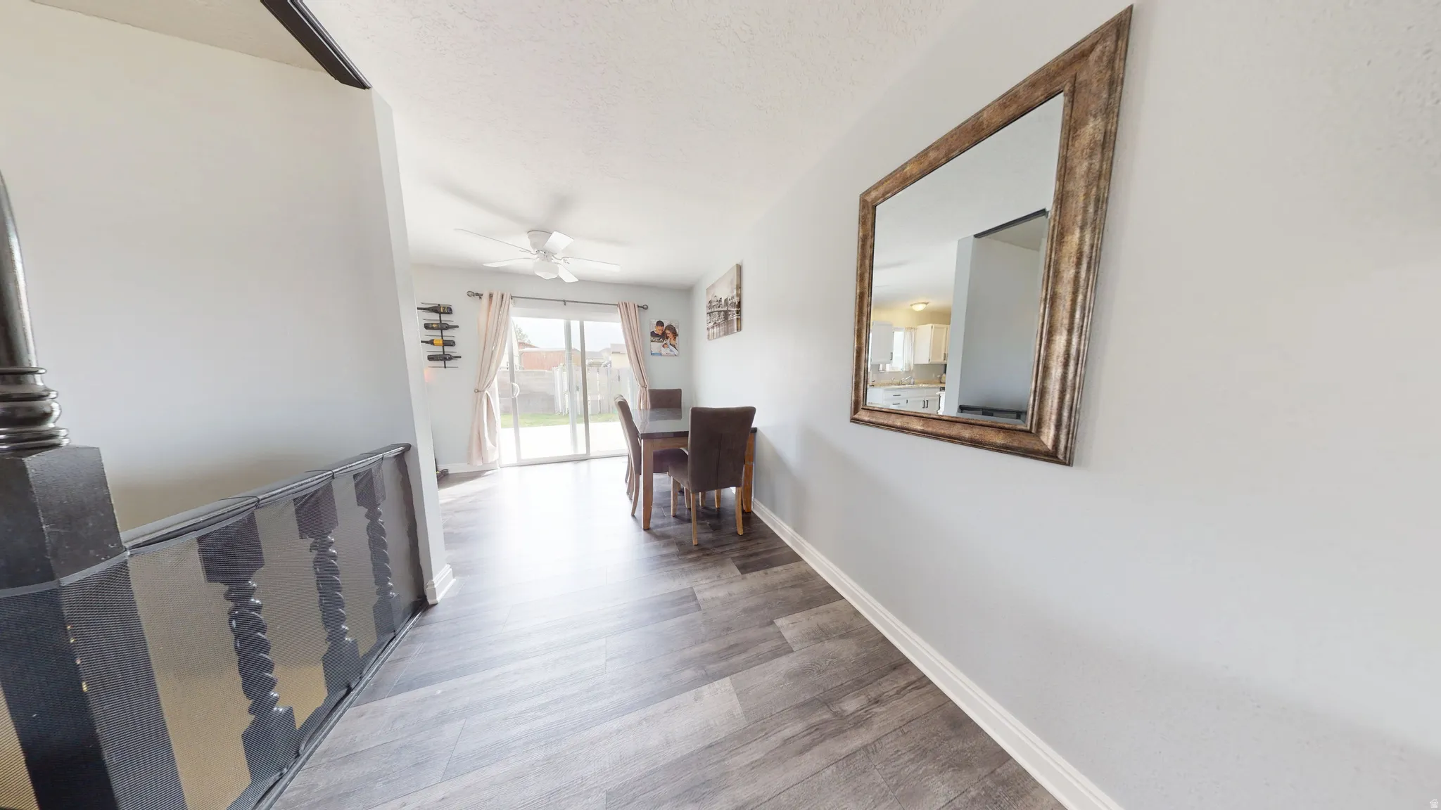Hall featuring light wood finished floors and a textured ceiling