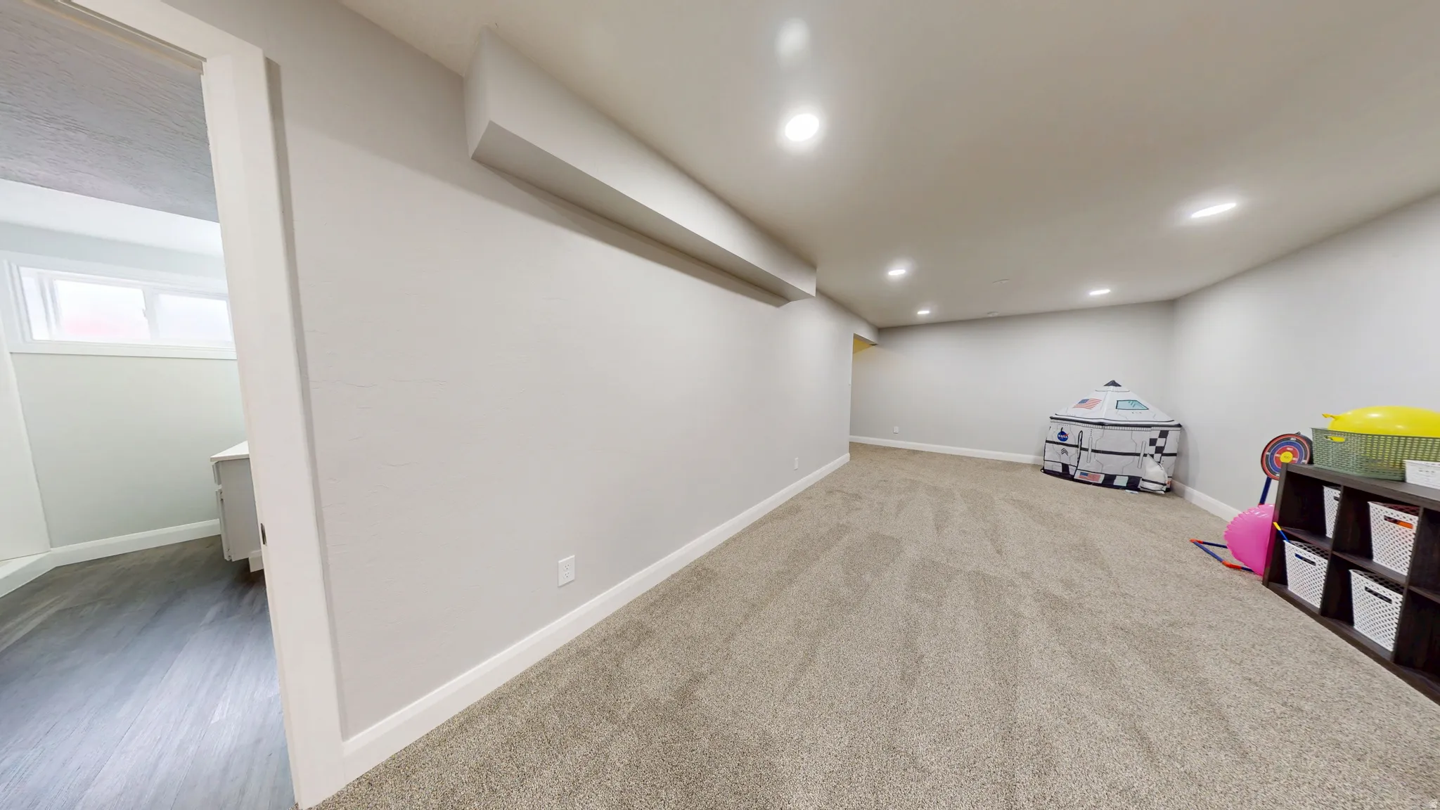 Recreation room with recessed lighting and light carpet