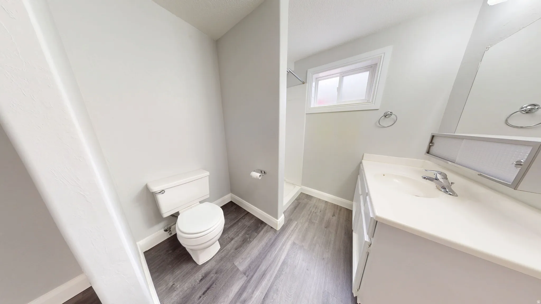 Full bathroom with vanity, light wood-type flooring, and walk in shower