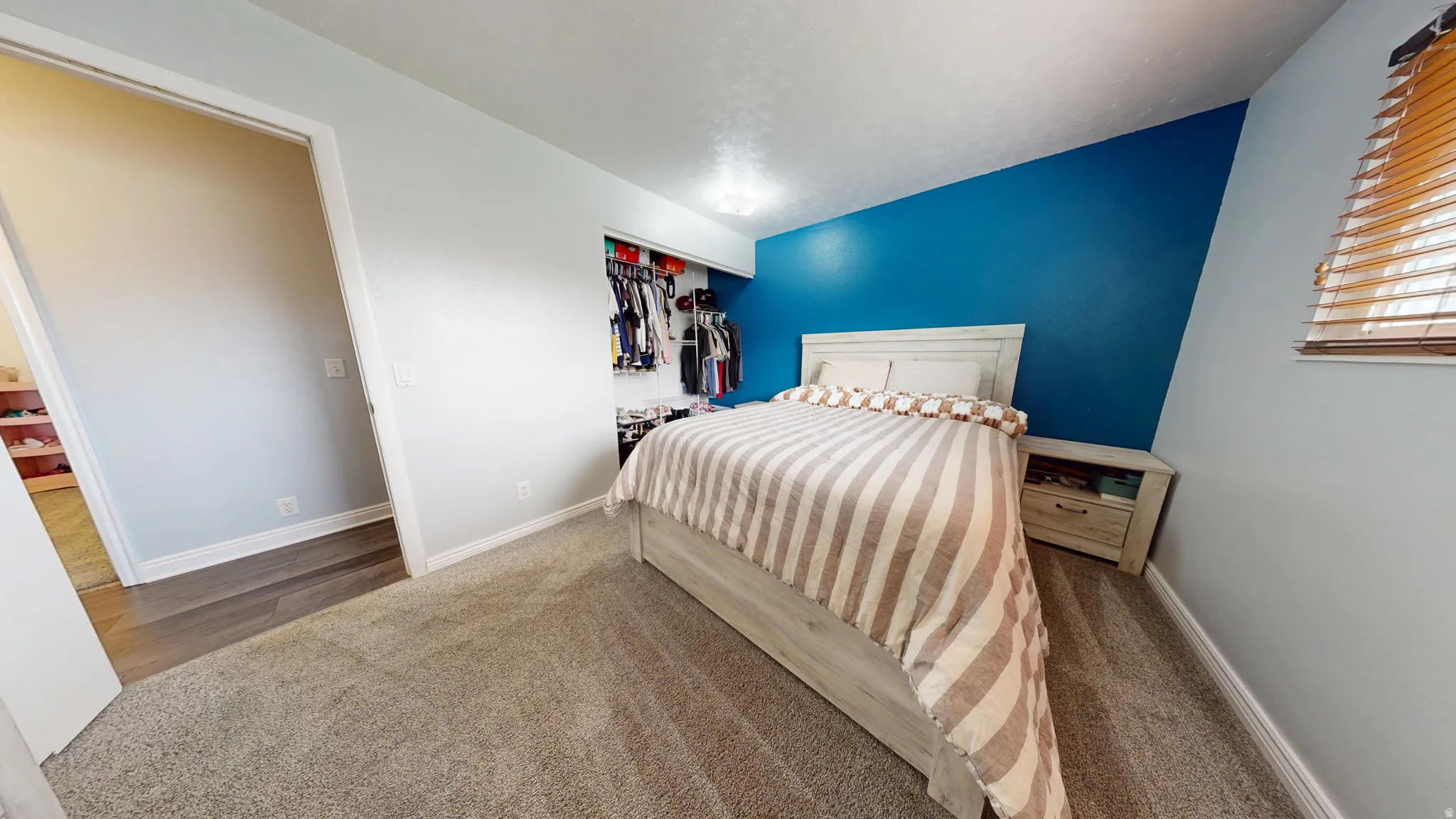 Bedroom with dark carpet and a closet