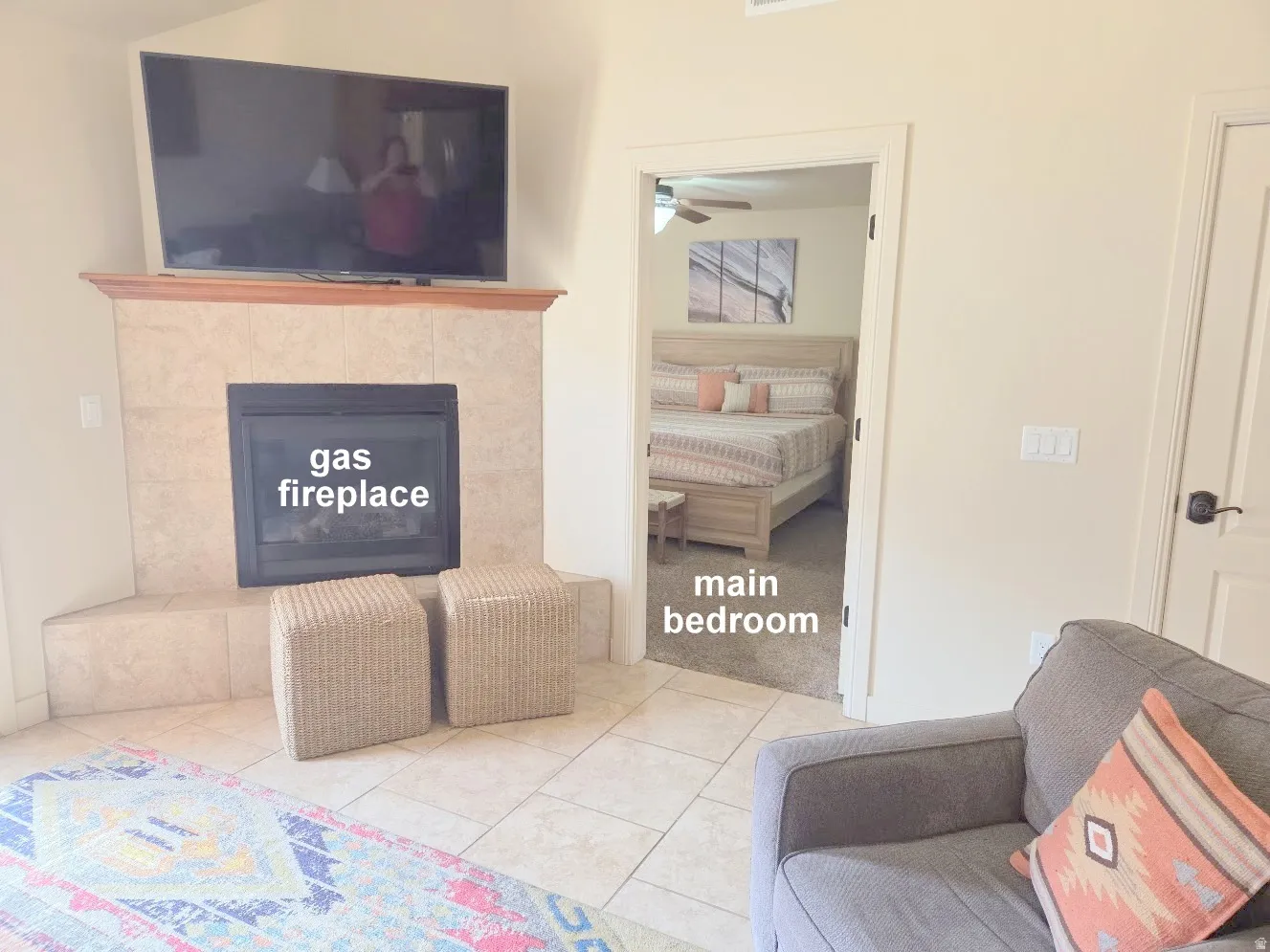 Corner fireplace with tile surround and wood mantel