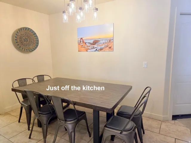 Dining room with light tile patterned floors just off the kitchen.