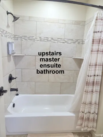 2nd master ensuite full bathroom with shower / bathtub combination with curtain