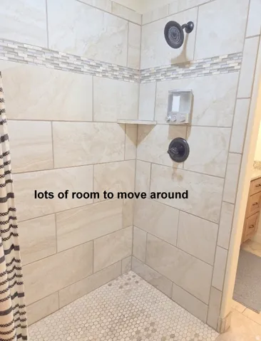 Master ensuite bathroom featuring tiled shower and vanity