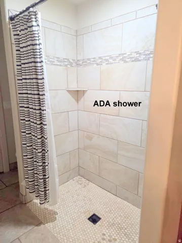 Master ensuite bathroom featuring a shower stall and tile patterned floors