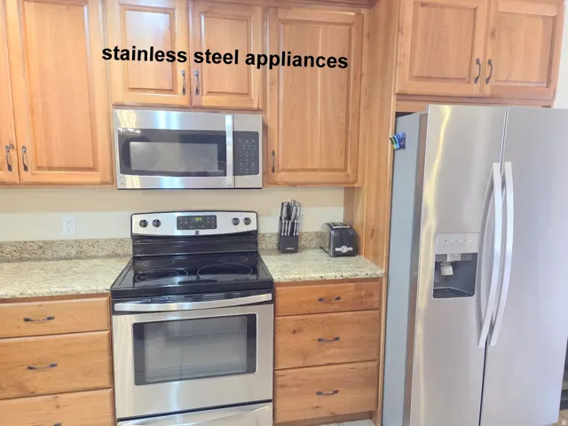 Kitchen with stainless steel appliances and granite counters