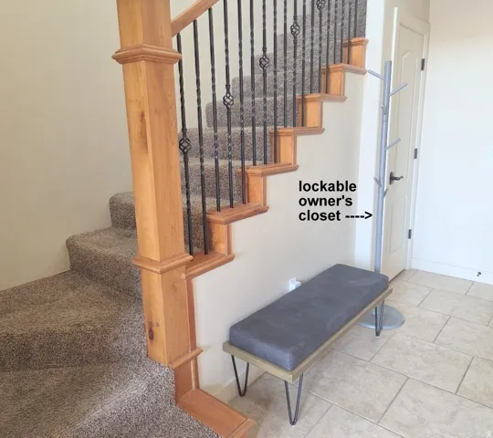 Staircase to upstairs bedrooms with tile patterned floors and baseboards