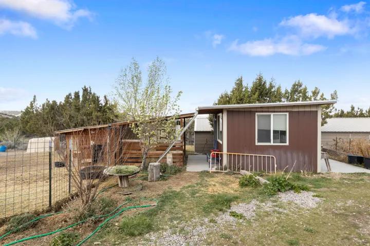 View of front of house featuring an outdoor structure, exterior structure, and a patio