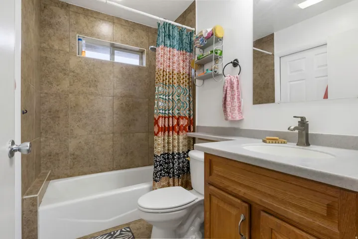 Bathroom featuring vanity and shower / tub combo