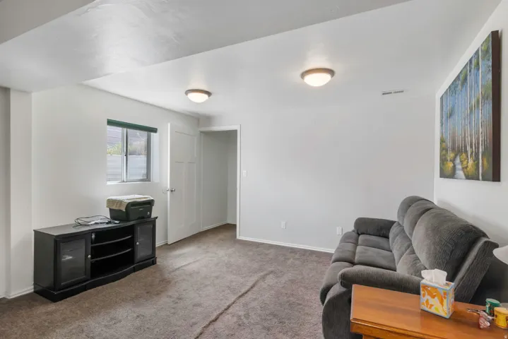 Carpeted living area featuring baseboards