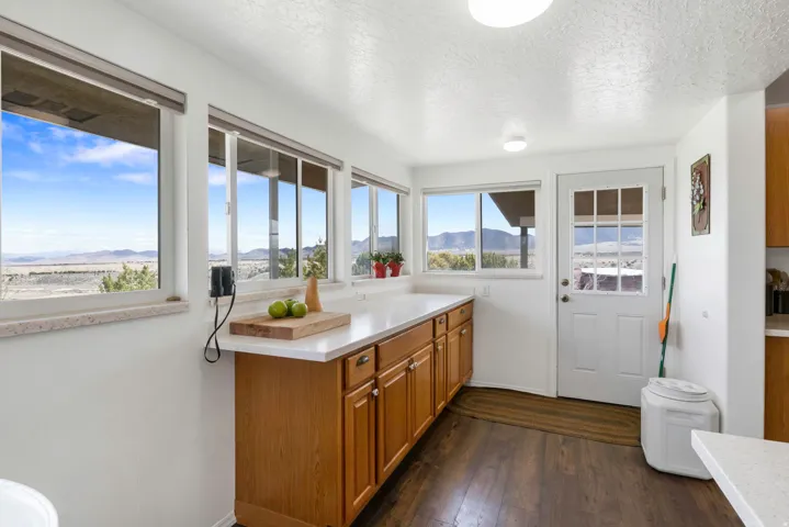 Kitchen featuring wood finish cabinetry, dark wood-style floors, a textured ceiling, and a mountain view