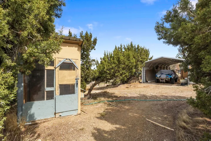 View of chicken coop featuring a carport