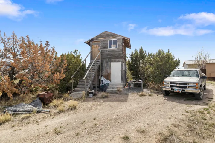 View of front of house featuring stairs and driveway