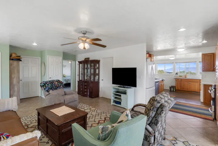 Living area featuring recessed lighting, light tile patterned flooring, and a ceiling fan